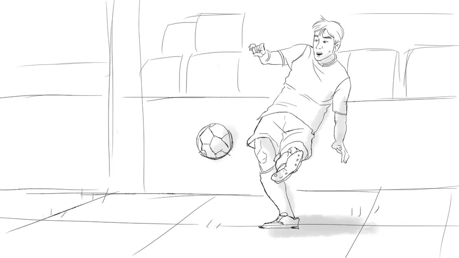 A young man kicks a football in a stadium.