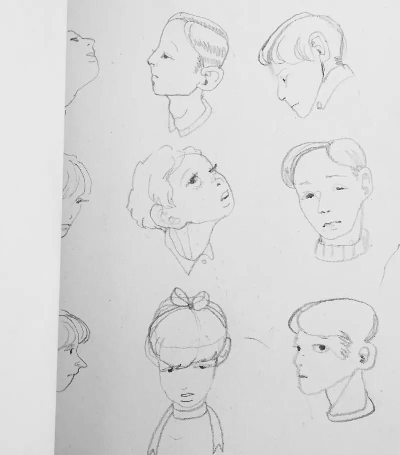 Pencil: a sketchbook page of eight small heads at different angles.