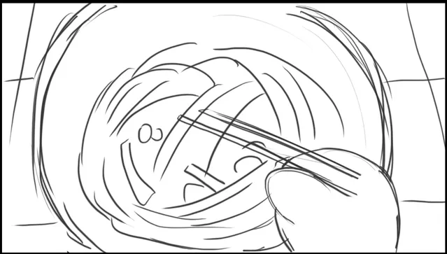 A bowl from above with chopsticks lifting noodles in a swirl.